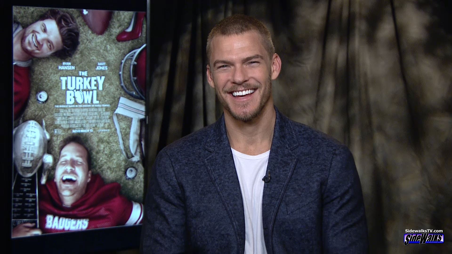 Alan Ritchson smiles during our interview
