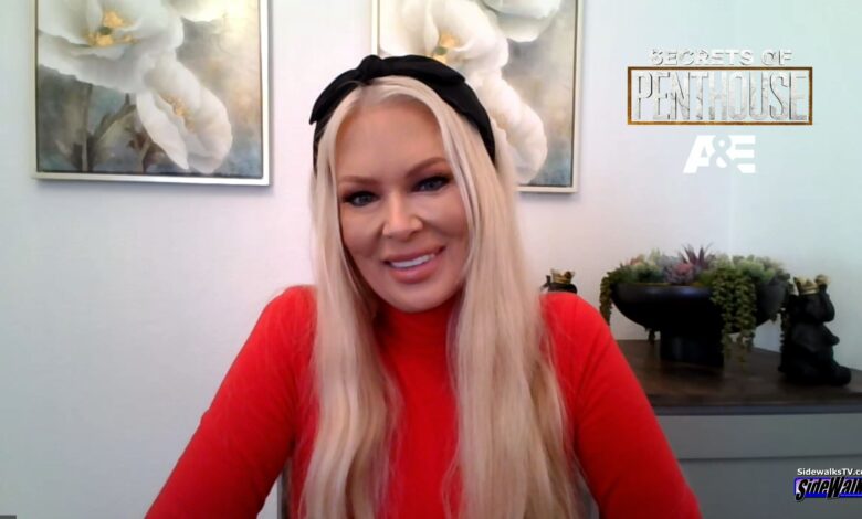 Jenna Jameson smiles in a red top