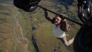 Tom Cruise plays Ethan Hunt hanging on a plane