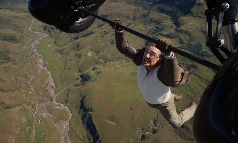 Tom Cruise plays Ethan Hunt hanging on a plane