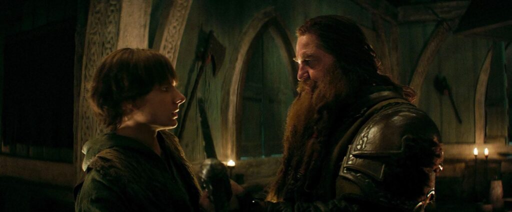 Hiccup (Mason Thames) and Stoick (Gerard Butler)