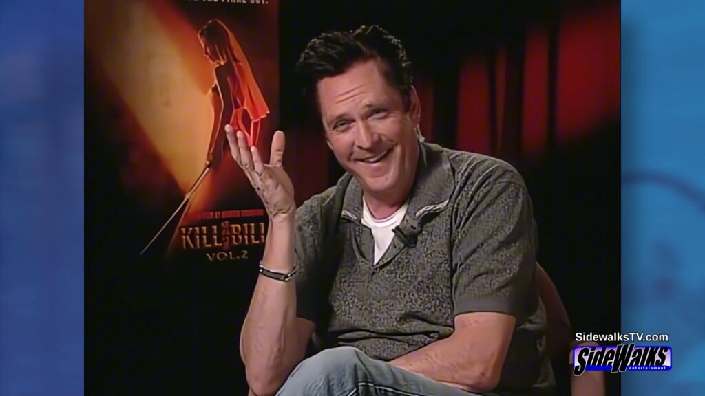 Michael Madsen smiled with hand up