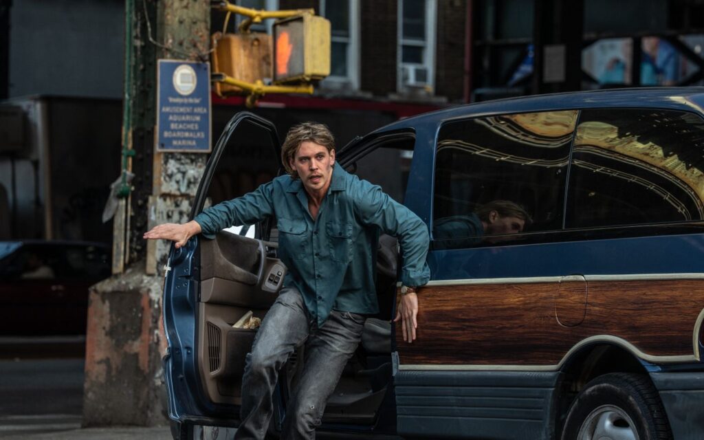 Austin Butler exiting a car in a still image from the film