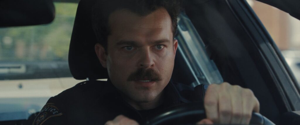 ALDEN EHRENREICH driving in a still image from Weapons
