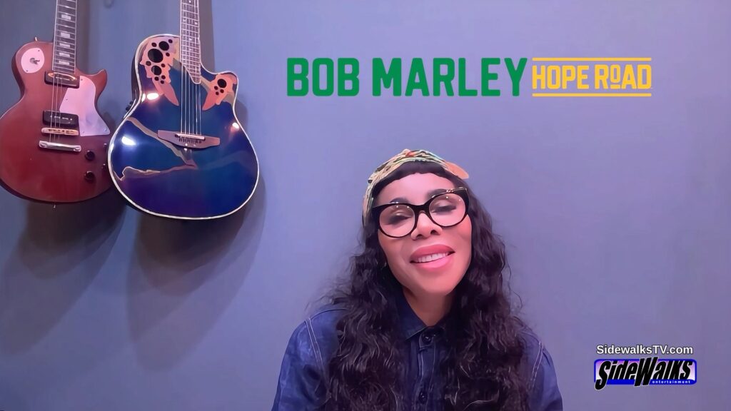 Cedella Marley with the Bob Marley Hope Road logo on top of the screen