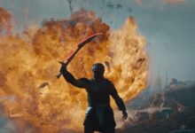 PREDATOR: BADLANDS with fire behind the creature