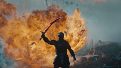 PREDATOR: BADLANDS with fire behind the creature