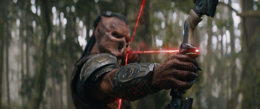 Dek (Dimitrius Schuster-Koloamatangi holding a weapon