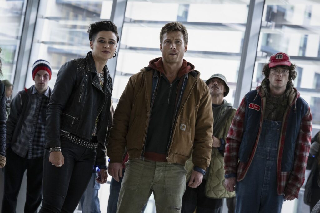 Katy O'Brian, Glen Powell and Martin Herlihy in a still from "The Running Man"