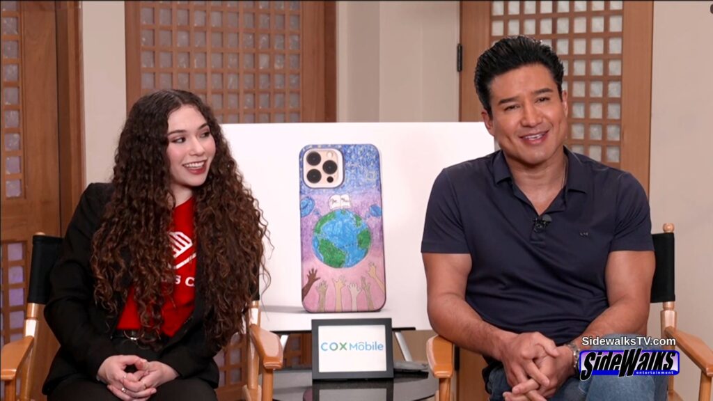 Ximena and Mario Lopez sitting in chairs and being interviewed.