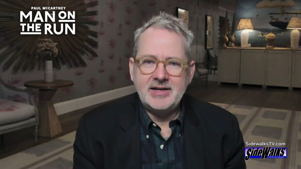 Morgan Neville sitting and being interviewed