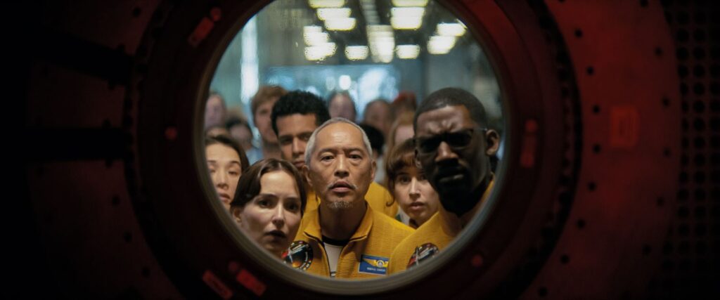 Looking through a window, Milana Vayntrub stars as Olesya Ilyukhina and Ken Leung as Yao.