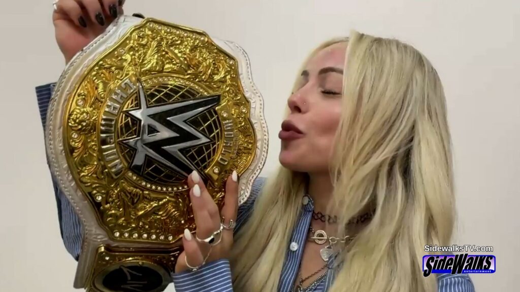 Liv Morgan kissing her WWE Women's Championship belt.