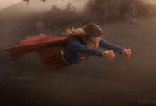 Milly Alcock as SUPERGIRL flying in the sky.