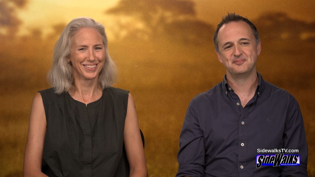 Sophie Darlington smiling and Simon Blakeney on the set being interviewed.