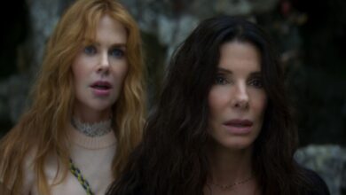 NICOLE KIDMAN as Gillian Owens and SANDRA BULLOCK as Sally Owens standing next to each other.