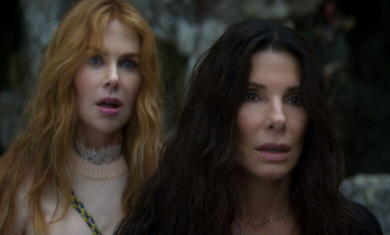 NICOLE KIDMAN as Gillian Owens and SANDRA BULLOCK as Sally Owens standing next to each other.