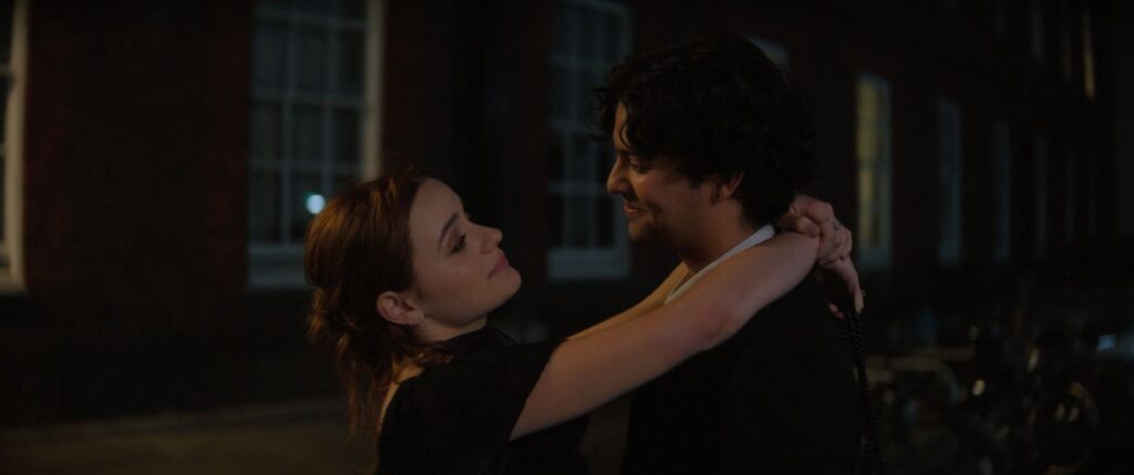 JOEY KING as Kylie and XOLO MARIDUEÑA as Gideon holding each other.