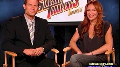 Casper Van Dien and Jolene Blalock sitting with the movie's logo behind them on a monitor