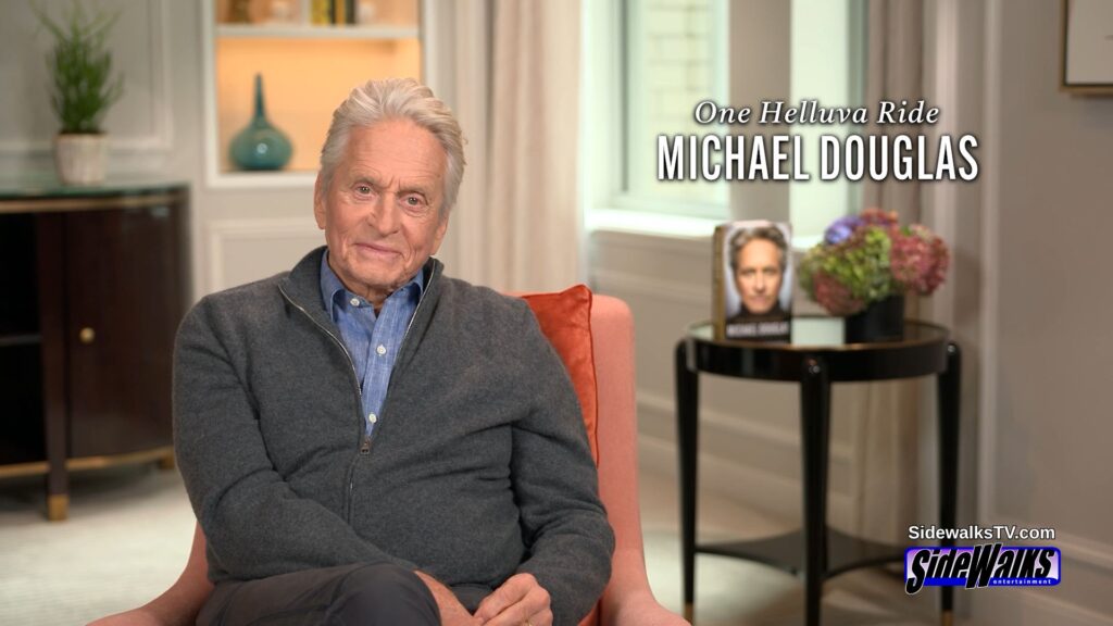 Michael Douglas while sitting. His book and graphic are on the right side.