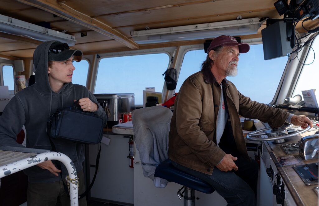Austin Abrams as Jay Gardiner and Josh Brolin as Mitt on a boat.