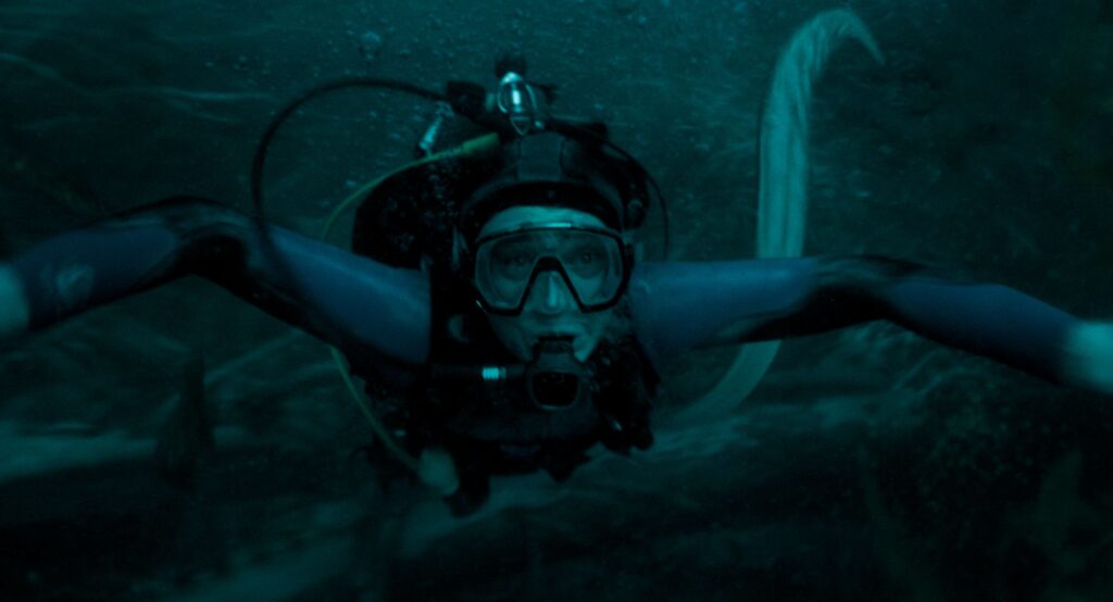 Austin Abrams as Jay Gardiner swimming